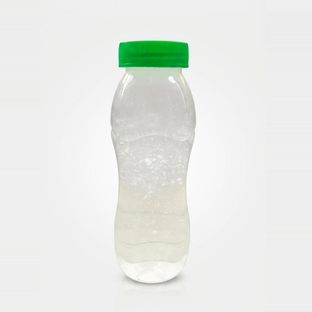 PrimeCoco instant coconut water powder with coconut meat, shown reconstituted in a bottle